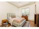 Cozy bedroom with plaid bed frame, hardwood floors, and natural light from the window at 4785 Brinkley Ln, Atlanta, GA 30342