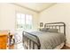 Serene bedroom featuring a metal bed frame, wood floors, and a sunlit window at 4785 Brinkley Ln, Atlanta, GA 30342