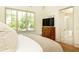 Inviting bedroom with hardwood floors and a view to the ensuite bathroom, showcasing a comfortable and stylish design at 4785 Brinkley Ln, Atlanta, GA 30342