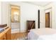 Bedroom showcasing bathroom access, neutral walls, and wood floors, all enhanced by bright natural light at 4785 Brinkley Ln, Atlanta, GA 30342