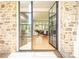 Elegant entryway with steel frame glass doors, stone walls, and a glimpse of the inviting interior at 4785 Brinkley Ln, Atlanta, GA 30342