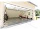 Spacious three-car garage with an open door, revealing ample storage space for vehicles and equipment at 4785 Brinkley Ln, Atlanta, GA 30342