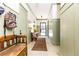 Inviting hallway with olive green wainscoting, tiled floors, and antique furniture, creating a charming entrance at 4785 Brinkley Ln, Atlanta, GA 30342