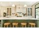 Stylish kitchen island featuring marble countertops, wooden stools, and modern fixtures at 4785 Brinkley Ln, Atlanta, GA 30342