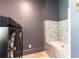 Modern laundry room with blue tiled dog wash station and sleek, front-load washer and dryer for added convenience at 4785 Brinkley Ln, Atlanta, GA 30342