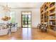 Spacious living area with hardwood floors, custom bookshelf, and ample natural light at 4785 Brinkley Ln, Atlanta, GA 30342