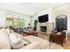 Bright living room featuring stone fireplace, large windows, and comfortable seating at 4785 Brinkley Ln, Atlanta, GA 30342