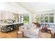 Open-concept living space featuring a gourmet kitchen, cozy living area, and dining space at 4785 Brinkley Ln, Atlanta, GA 30342