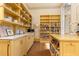 Well-appointed pantry with custom yellow cabinets and shelving, offering ample storage and a modern design at 4785 Brinkley Ln, Atlanta, GA 30342