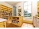 Bright, expansive pantry features custom yellow cabinetry, shelves stocked with goods, and large windows overlooking a green lawn at 4785 Brinkley Ln, Atlanta, GA 30342