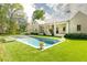 Beautiful backyard with a refreshing pool surrounded by lush greenery and manicured lawn, ideal for outdoor relaxation at 4785 Brinkley Ln, Atlanta, GA 30342