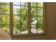 Bedroom view through a large window showcasing lush greenery, offering a peaceful and private ambiance at 4785 Brinkley Ln, Atlanta, GA 30342
