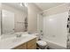 Standard bathroom featuring a shower-tub combo, white tile, and a vanity with a sink at 930 Palmer Rd, Lithonia, GA 30058