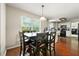 Cozy dining area featuring dark wood table and chairs, with natural light from window at 930 Palmer Rd, Lithonia, GA 30058