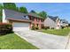 Attractive brick-front home with attached two-car garage and large driveway, surrounded by green lawn at 930 Palmer Rd, Lithonia, GA 30058