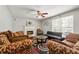 Inviting living room with a ceiling fan, a cozy fireplace and ample seating, perfect for relaxation at 930 Palmer Rd, Lithonia, GA 30058