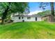 Well-maintained backyard with lush grass and the back of the house at 1660 Mallard Cir, Conley, GA 30288