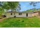 White home exterior with a well-maintained lawn surrounded by mature trees at 1660 Mallard Cir, Conley, GA 30288