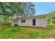 Exterior home view of white-painted brick with ample backyard space and mature trees at 1660 Mallard Cir, Conley, GA 30288