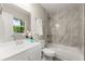 Updated bathroom with modern vanity, tiled shower-tub, and natural light from window at 1660 Mallard Cir, Conley, GA 30288