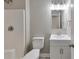 Bright bathroom featuring a shower and tub, vanity with storage and modern lighting at 1660 Mallard Cir, Conley, GA 30288