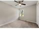 Cozy bedroom featuring neutral paint, ceiling fan, and a window view of the outdoors at 1660 Mallard Cir, Conley, GA 30288