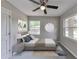 Cozy bedroom with neutral tones, carpet, ceiling fan, and natural light from multiple windows at 1660 Mallard Cir, Conley, GA 30288