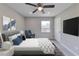 Modern bedroom with sleek furniture, comfortable bedding, TV, and ample natural light at 1660 Mallard Cir, Conley, GA 30288