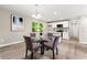 Well-lit dining area with a glass table, seating for four, and views of the updated kitchen at 1660 Mallard Cir, Conley, GA 30288