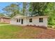 Charming one-story home with a well-maintained front yard and painted white brick at 1660 Mallard Cir, Conley, GA 30288