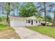 Charming one-story home with a well-maintained front yard and painted white brick at 1660 Mallard Cir, Conley, GA 30288
