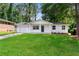 Charming one-story home featuring a lush front yard, a welcoming entrance, and a convenient attached garage at 1660 Mallard Cir, Conley, GA 30288