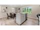 Modern kitchen island with stainless steel appliances and marble countertops, adjacent to a dining area at 1660 Mallard Cir, Conley, GA 30288