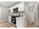 Efficient kitchen with stainless steel appliances, white cabinets, and ample storage space at 1660 Mallard Cir, Conley, GA 30288