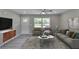 Bright living room with large windows, hardwood floors, and modern decor at 1660 Mallard Cir, Conley, GA 30288