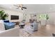 Bright living room with modern decor, featuring hardwood floors, stylish furniture, and a ceiling fan at 1660 Mallard Cir, Conley, GA 30288