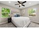 Beautiful bedroom with plush carpet, large windows, and a comfortable queen-sized bed at 1660 Mallard Cir, Conley, GA 30288