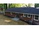 View of the backyard with a brick house, featuring a patio and well-maintained lawn at 257 E Simon Nw Ter, Atlanta, GA 30318