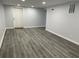 Spacious finished basement area with grey flooring and a bright white door at 257 E Simon Nw Ter, Atlanta, GA 30318