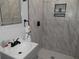 This bathroom includes a shower, sink, hexagon tile floor, and a modern mirror with tiling at 257 E Simon Nw Ter, Atlanta, GA 30318