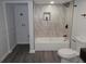 Stylish bathroom with a shower-over-tub featuring marble-style tile and updated fixtures at 257 E Simon Nw Ter, Atlanta, GA 30318