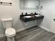 Modern bathroom features a double sink vanity with a black countertop and sleek fixtures at 257 E Simon Nw Ter, Atlanta, GA 30318