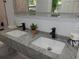 Bathroom featuring a double vanity with modern faucets and a stylish mirror at 257 E Simon Nw Ter, Atlanta, GA 30318