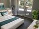 The staged bedroom features a bed, natural light from a window, and a small side bench with decor at 257 E Simon Nw Ter, Atlanta, GA 30318