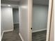 Hallway leading to rooms with gray-toned flooring and neutral walls at 257 E Simon Nw Ter, Atlanta, GA 30318