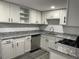 Bright kitchen with white cabinets, granite countertops, and stainless steel appliances at 257 E Simon Nw Ter, Atlanta, GA 30318