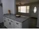 Kitchen island with granite countertops, white cabinets, and an open view of the living area at 257 E Simon Nw Ter, Atlanta, GA 30318