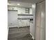 Open kitchen featuring stainless steel appliances, granite countertops, and bright white cabinets at 257 E Simon Nw Ter, Atlanta, GA 30318