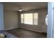 Bright living room featuring a window with blinds and luxury vinyl plank flooring at 257 E Simon Nw Ter, Atlanta, GA 30318