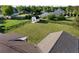 Aerial view showcasing the backyard, shed, and surrounding landscape with blue skies at 275 Crowe Springs Nw Rd, Cartersville, GA 30121
